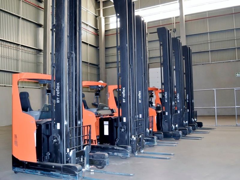 Spacious industrial warehouse facility featuring high ceilings, exposed steel structural elements, durable concrete flooring, and integrated fire suppression systems.
