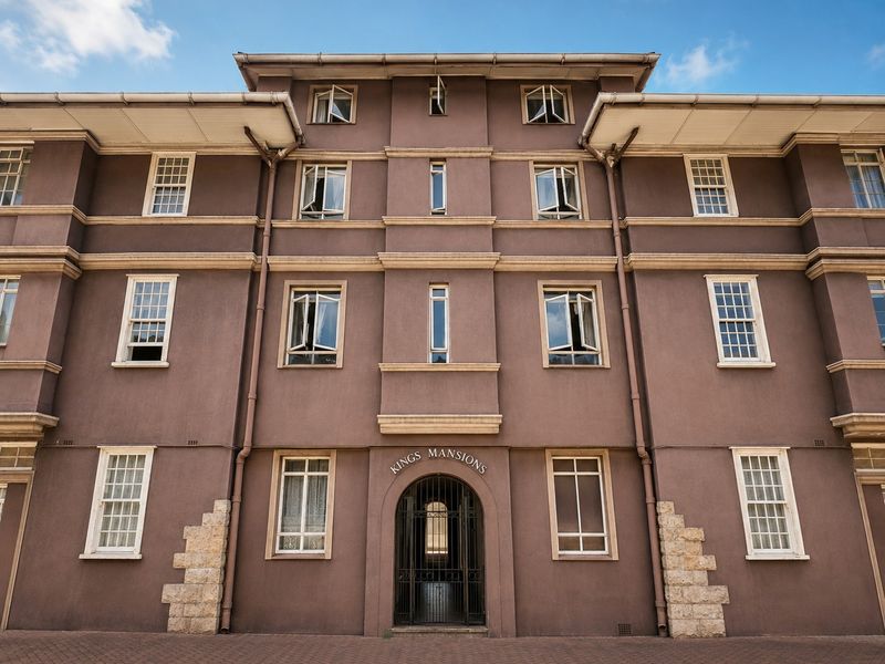 Front elevation of Kings Mansions, featuring a symmetrical facade with sash windows, stone detailing, and a secure arched entrance.
