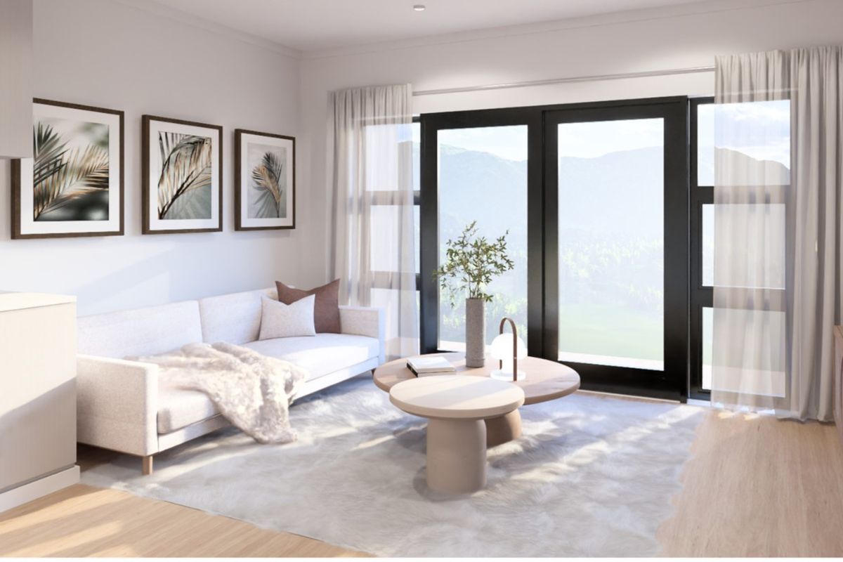 Modern open-plan living area featuring a compact kitchen with built-in appliances and large sliding doors leading to an outdoor view.