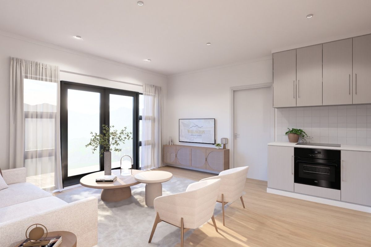 Modern open-plan living area featuring a contemporary kitchen with integrated appliances, light wood-look flooring, and large sliding doors providing ample natural light.