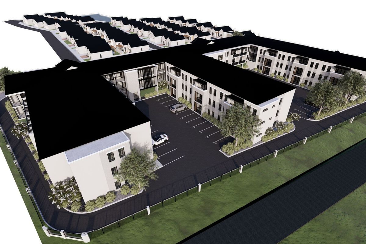 Aerial perspective of a modern retirement village complex featuring multi-story residential buildings, dedicated parking areas, and landscaped grounds.