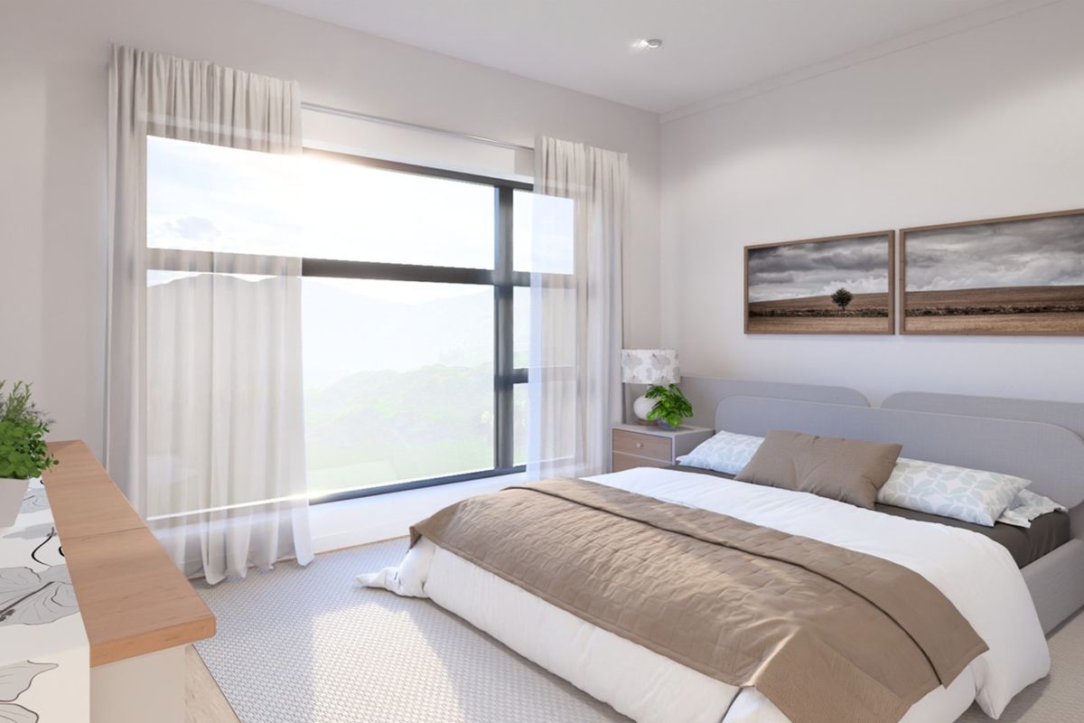 A modern, well-lit bedroom featuring a large window with scenic views, neutral finishes, and contemporary recessed lighting.