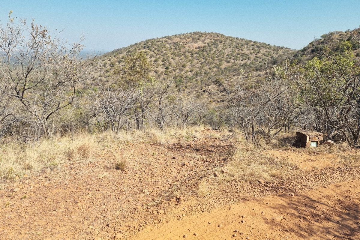 A scenic view of the natural hillside landscape and surrounding terrain on this vacant residential property.
