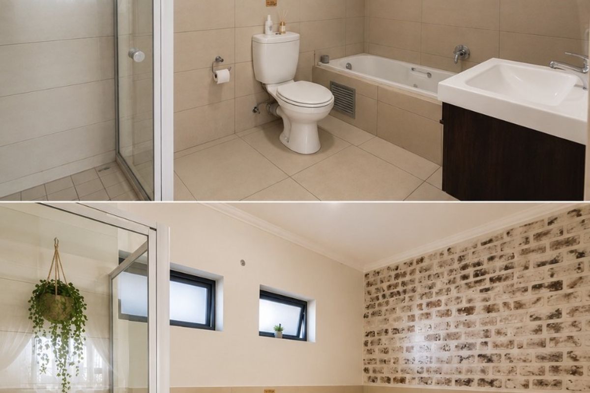 A well-maintained bathroom featuring a glass shower enclosure, bathtub, vanity basin, and a decorative brick-effect feature wall with neutral tiling.