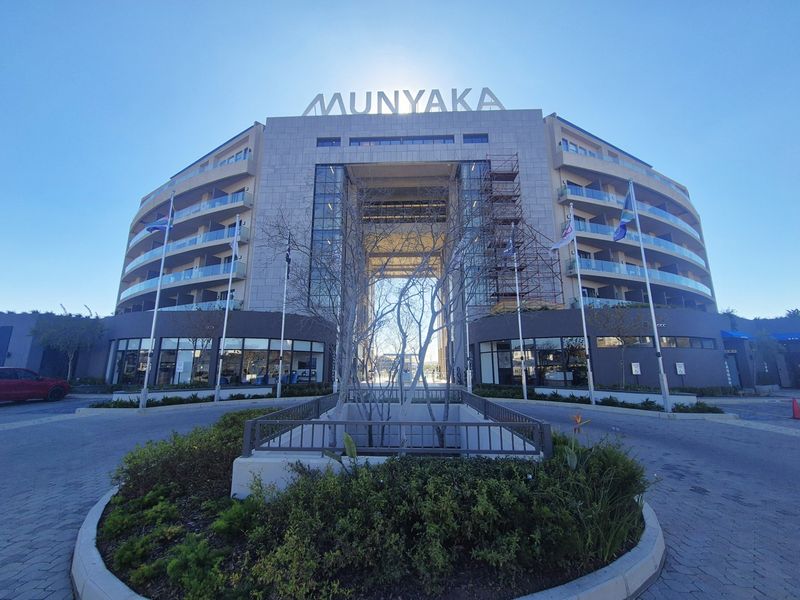 Front elevation of the Munyaka apartment complex, featuring a modern multi-story facade with glass balconies and a central architectural archway.