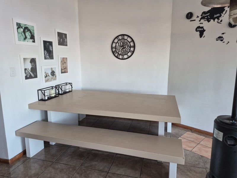 Dining area featuring built-in table and bench seating with tiled flooring.