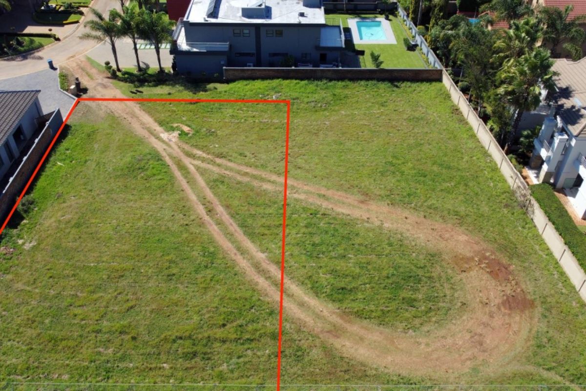 Aerial view of a vacant residential plot in a developed estate, showing clear boundaries and surrounding neighborhood infrastructure.