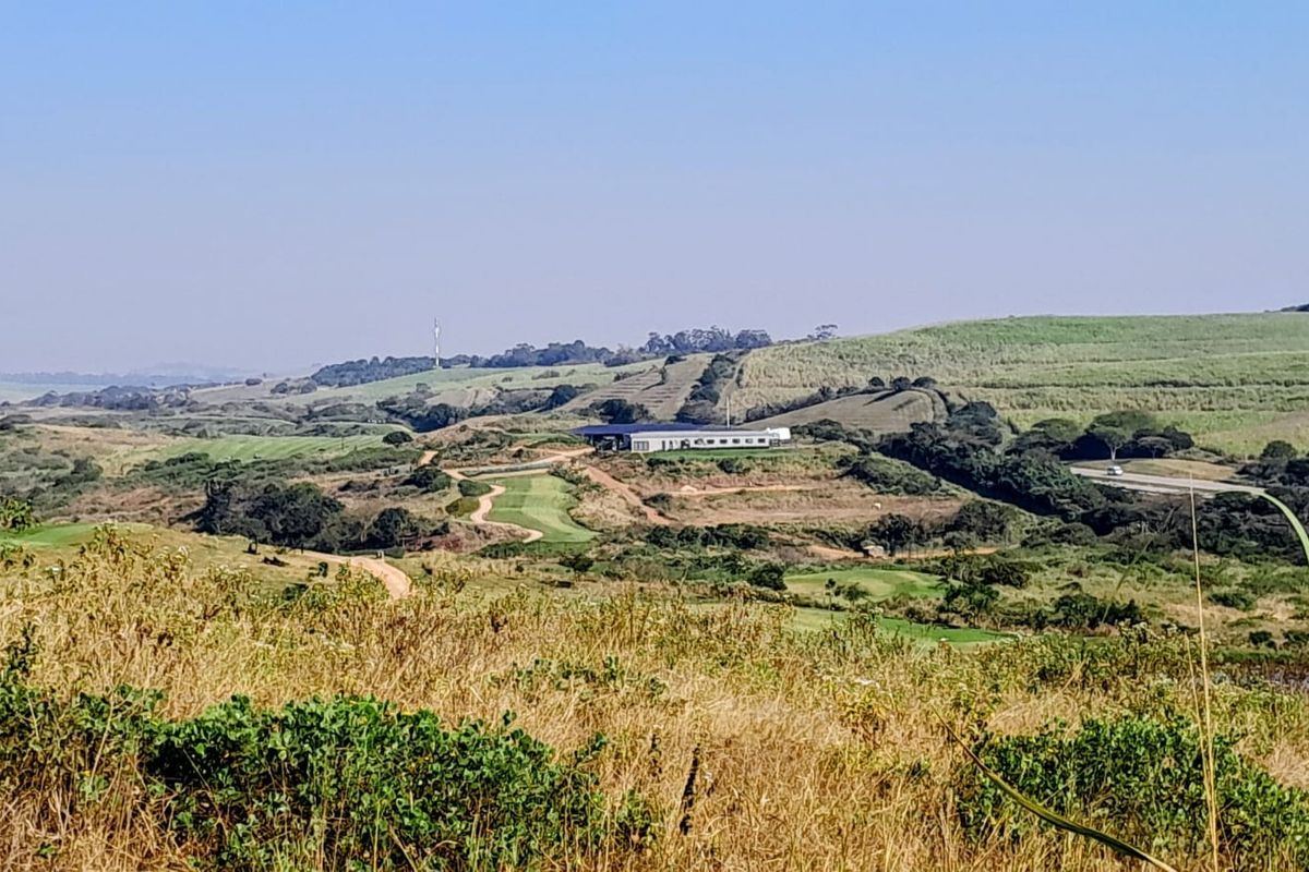Expansive elevated view overlooking rolling hills, natural landscape, and distant infrastructure, showcasing the scenic potential of this vacant residential land.