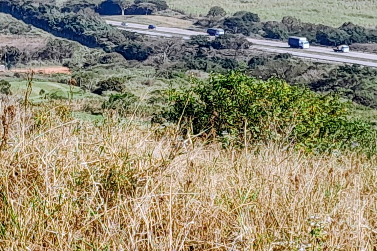 A view of the surrounding landscape and nearby highway from the vacant residential land.