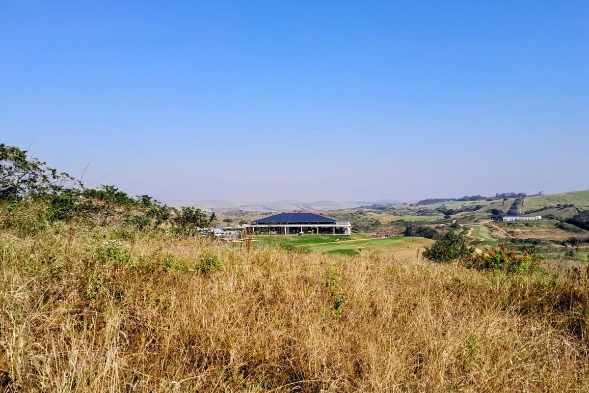 A scenic view overlooking the surrounding landscape and rolling hills, showcasing the natural beauty and open space of the residential land.