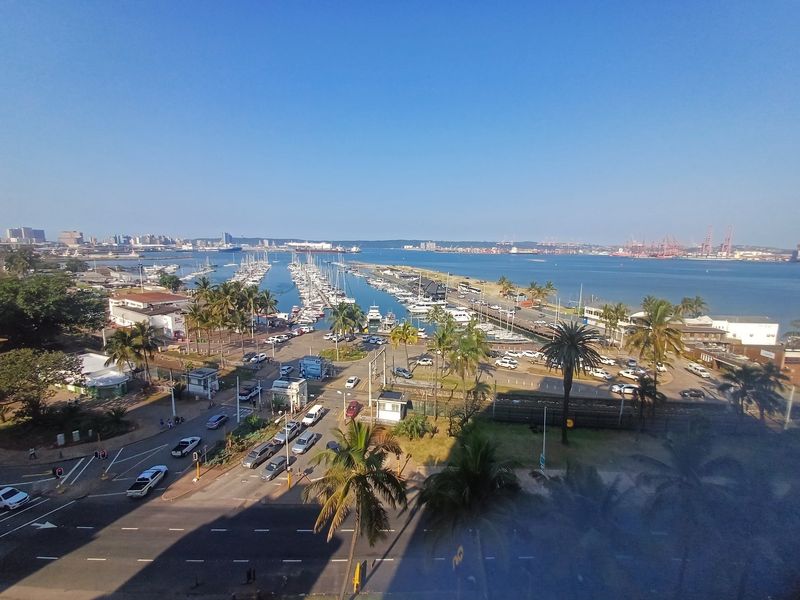 Elevated panoramic view overlooking the marina, harbor, and surrounding coastal cityscape.