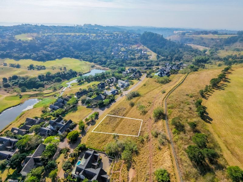 Aerial view of a vacant residential plot within a secure estate, highlighting the land boundaries and surrounding landscape.