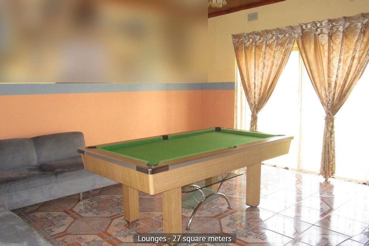 Spacious living area featuring tiled flooring and a sliding glass door providing natural light and access to the exterior.