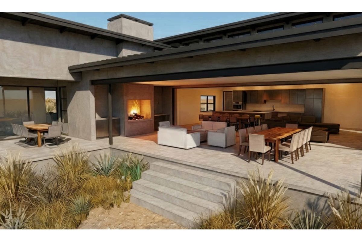 Spacious covered patio featuring a built-in fireplace, seamless indoor-outdoor flow, and direct access to the open-plan living and kitchen area.