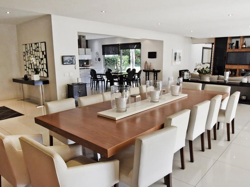 Spacious open-plan living and dining area featuring polished porcelain tiles, recessed lighting, and a seamless flow into the adjacent kitchen space.