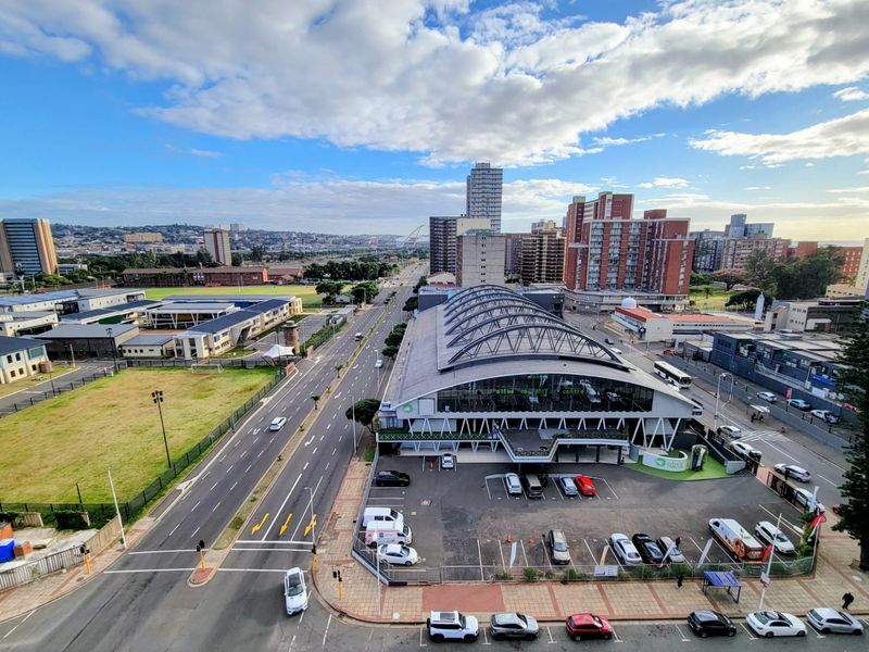 Elevated urban view overlooking the surrounding city infrastructure, commercial buildings, and main road networks.