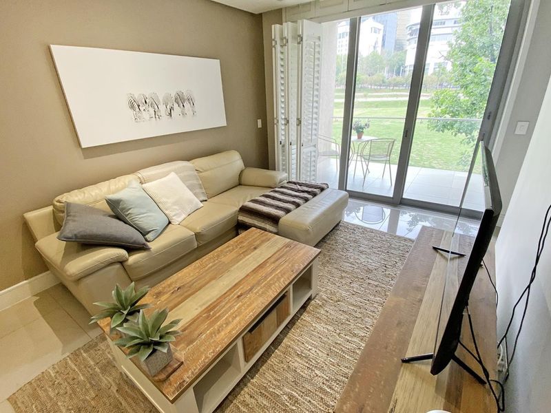 A well-maintained living room featuring large sliding glass doors that provide natural light and access to an outdoor patio area.