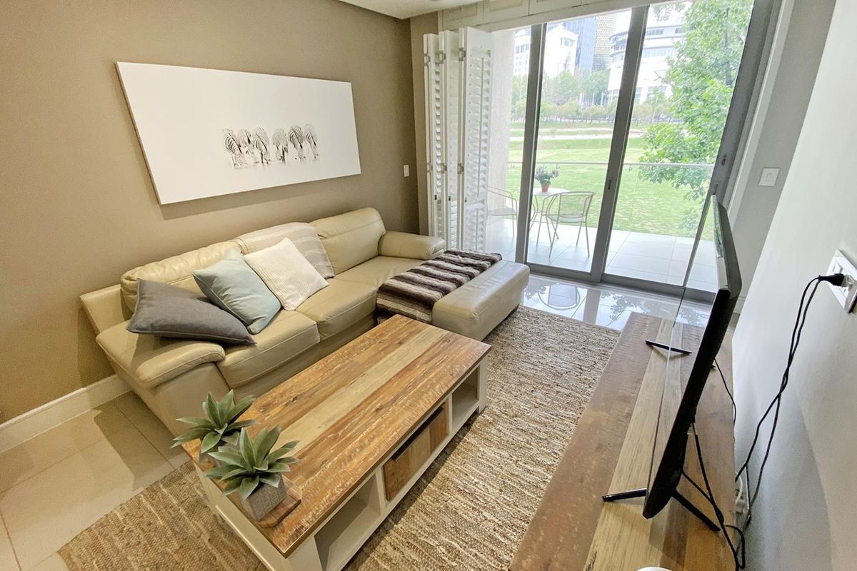 A well-maintained living room featuring large sliding glass doors that provide natural light and access to an outdoor patio area.