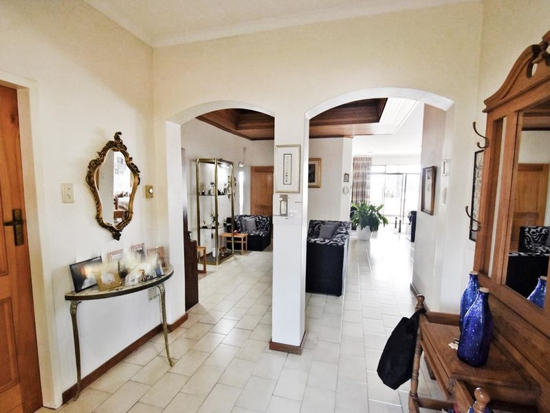 Entrance foyer featuring tiled flooring and arched architectural openings leading into the main living areas of the apartment.