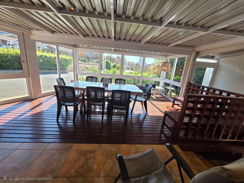 A covered outdoor patio featuring timber decking, tiled flooring, and large aluminium-framed windows, providing a bright and versatile space for outdoor dining and relaxation.