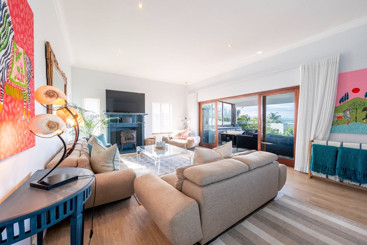 Spacious living room featuring a fireplace with mantelpiece, recessed lighting, and large sliding glass doors opening to an outdoor area.