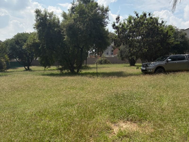 A spacious, open garden area featuring established mature trees and a grass lawn, providing a versatile outdoor space on the farm property.