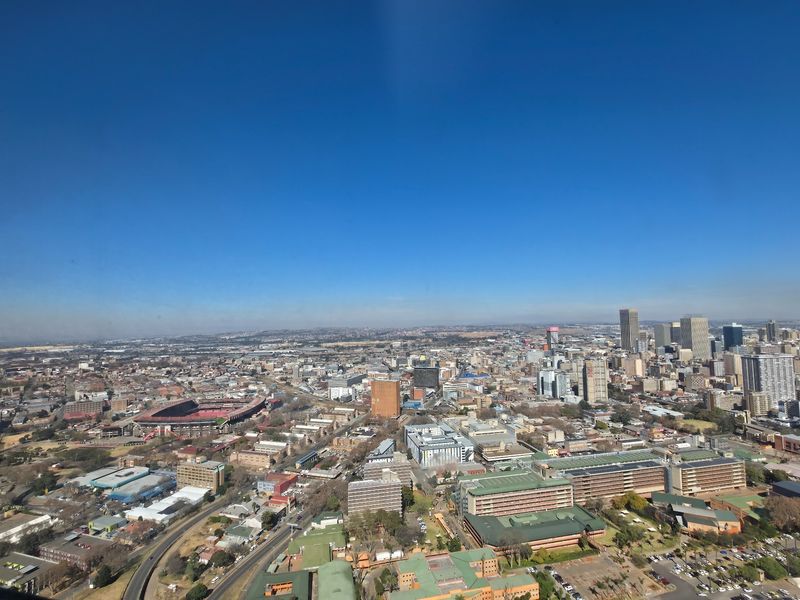 An elevated aerial view showcasing the surrounding urban cityscape and infrastructure.