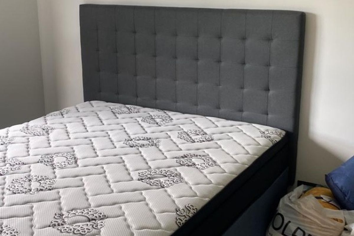 A bedroom featuring neutral wall finishes and tiled flooring.