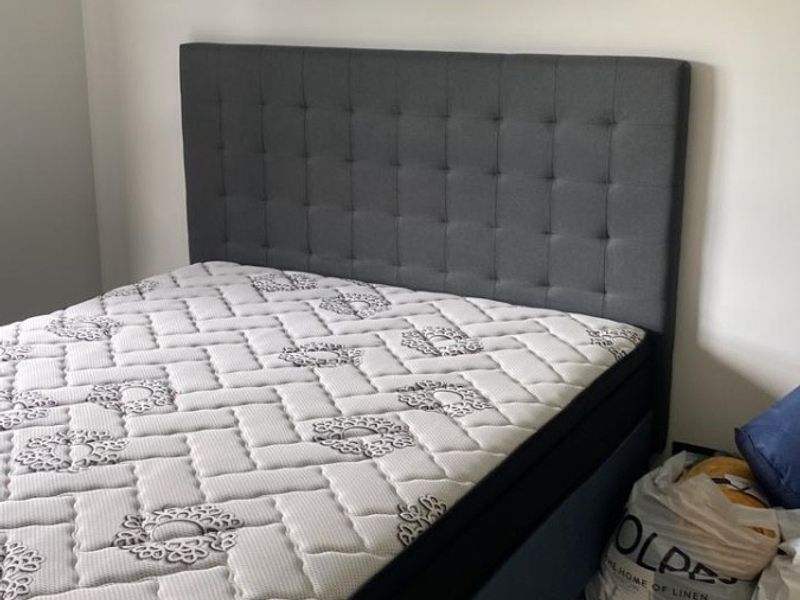 A bedroom featuring neutral wall finishes and tiled flooring.