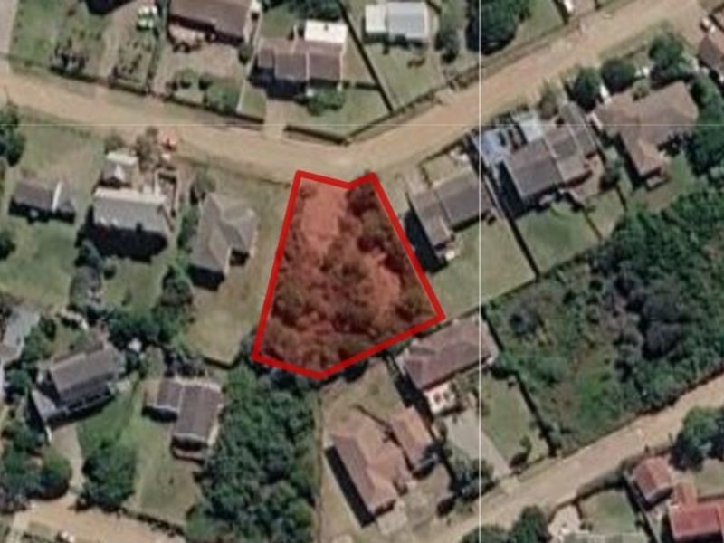 An aerial view showing the vacant residential plot highlighted in red, situated within an established suburban neighborhood.