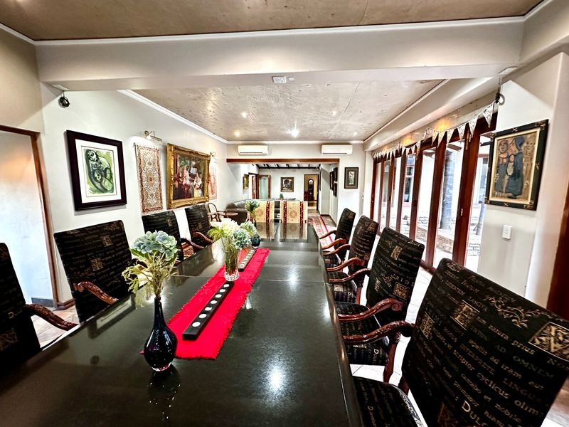 Spacious dining room featuring large sliding glass doors providing natural light and access to the exterior, complemented by split-system air conditioning.