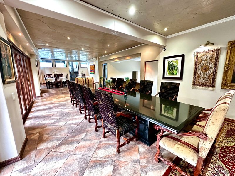 Spacious dining room featuring multi-level tiled flooring and recessed ceiling lighting, providing an expansive area suitable for large gatherings.