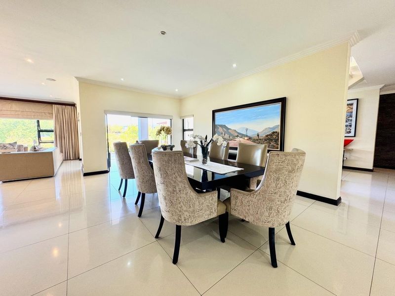Spacious dining area featuring polished porcelain tile flooring, recessed lighting, and large sliding glass doors providing natural light and access to the outdoor area.