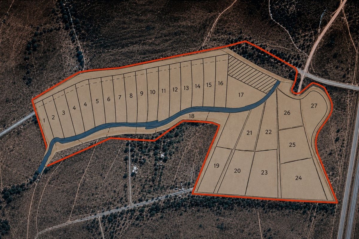 Aerial view of a residential land development showing subdivided plots and internal road infrastructure.
