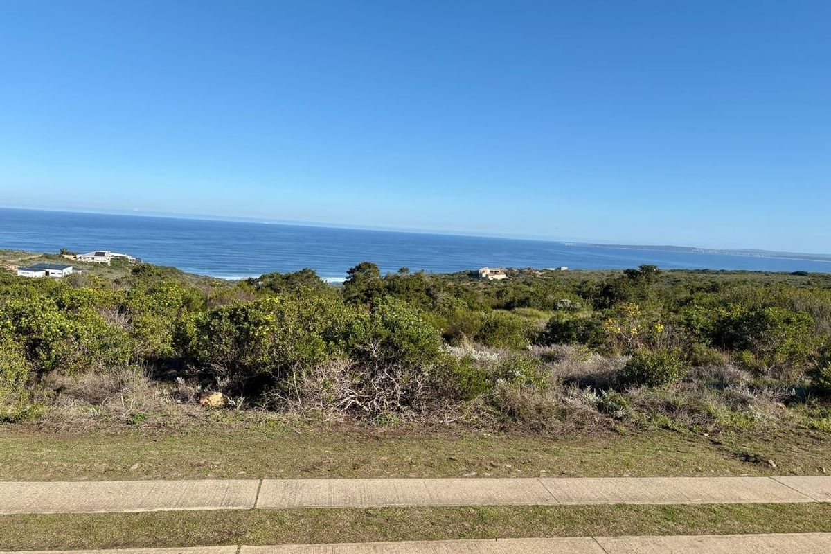 A scenic view overlooking the coastal landscape and ocean from the residential land plot.