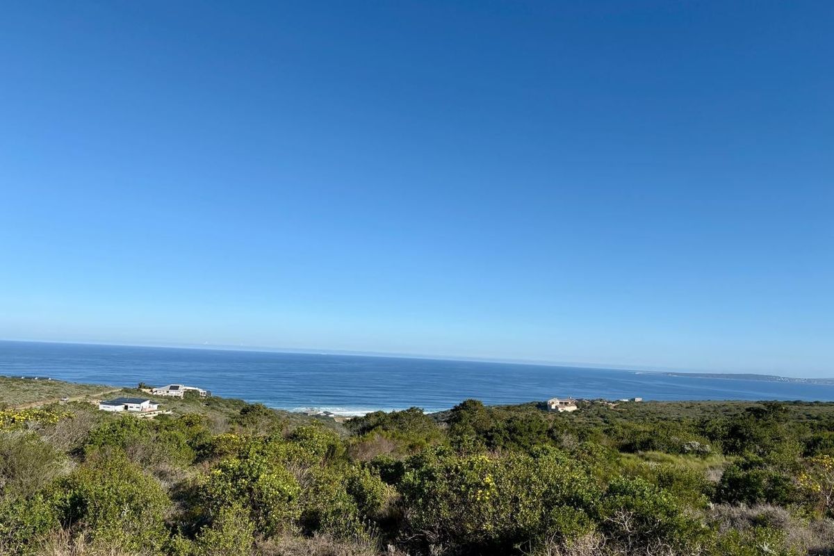 A scenic elevated view overlooking the coastal landscape and ocean, showcasing the natural surroundings of the vacant residential land.