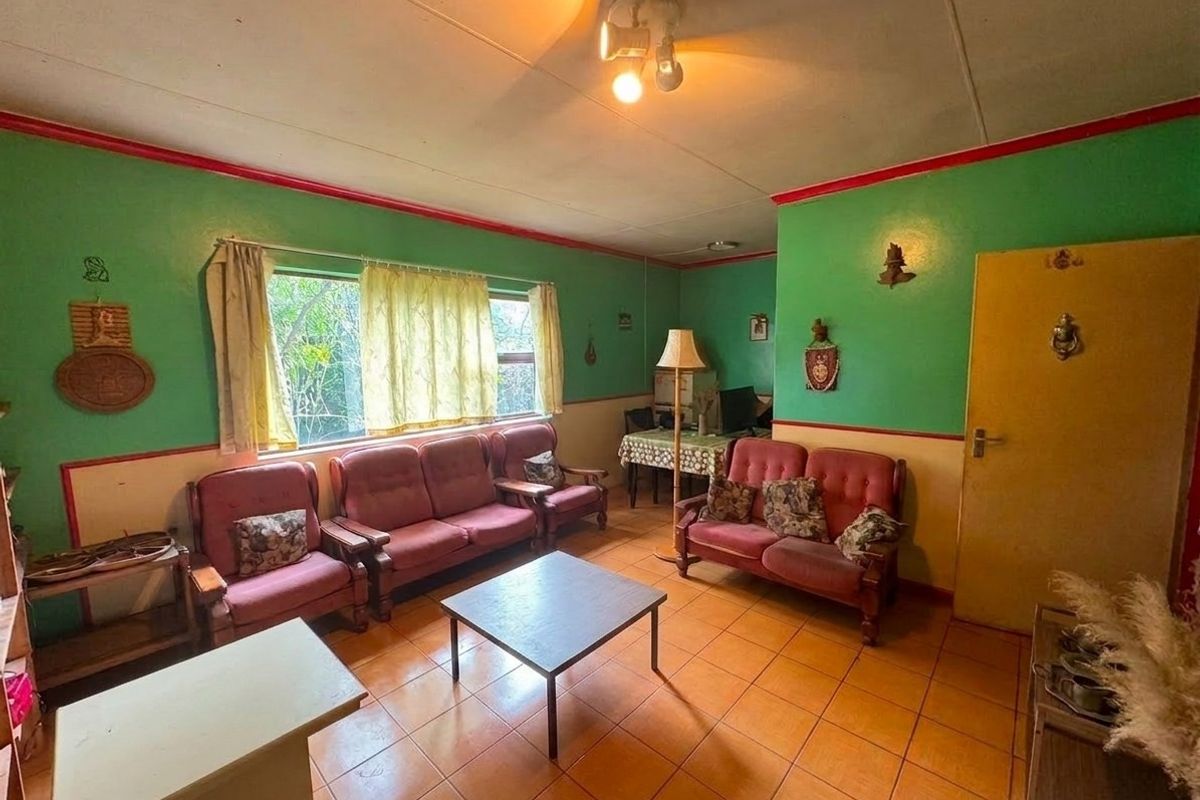 A living room featuring tiled flooring and dated wall finishes, offering a blank canvas for modernization and interior design updates.