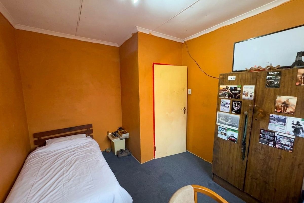 A bedroom featuring carpeted flooring and painted walls, requiring cosmetic updates to improve the overall aesthetic and condition of the space.