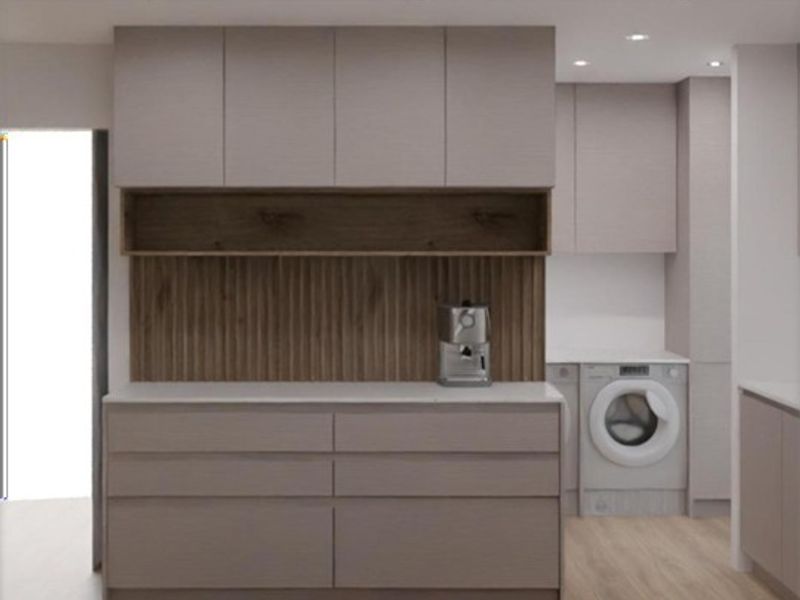 Modern laundry area featuring sleek built-in cabinetry, integrated washing machine, stone countertops, and a stylish timber-look splashback.
