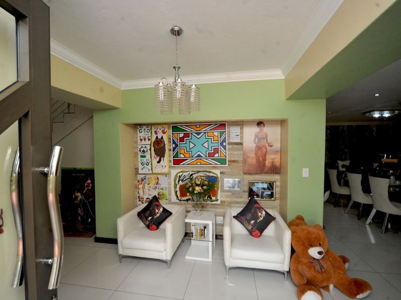 Entrance area featuring a recessed wall niche, tiled flooring, and decorative chandelier lighting, providing a welcoming transition into the home.