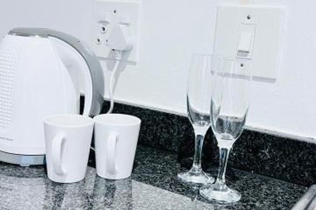 A close-up view of a kitchen countertop featuring granite surfaces and integrated electrical fixtures.