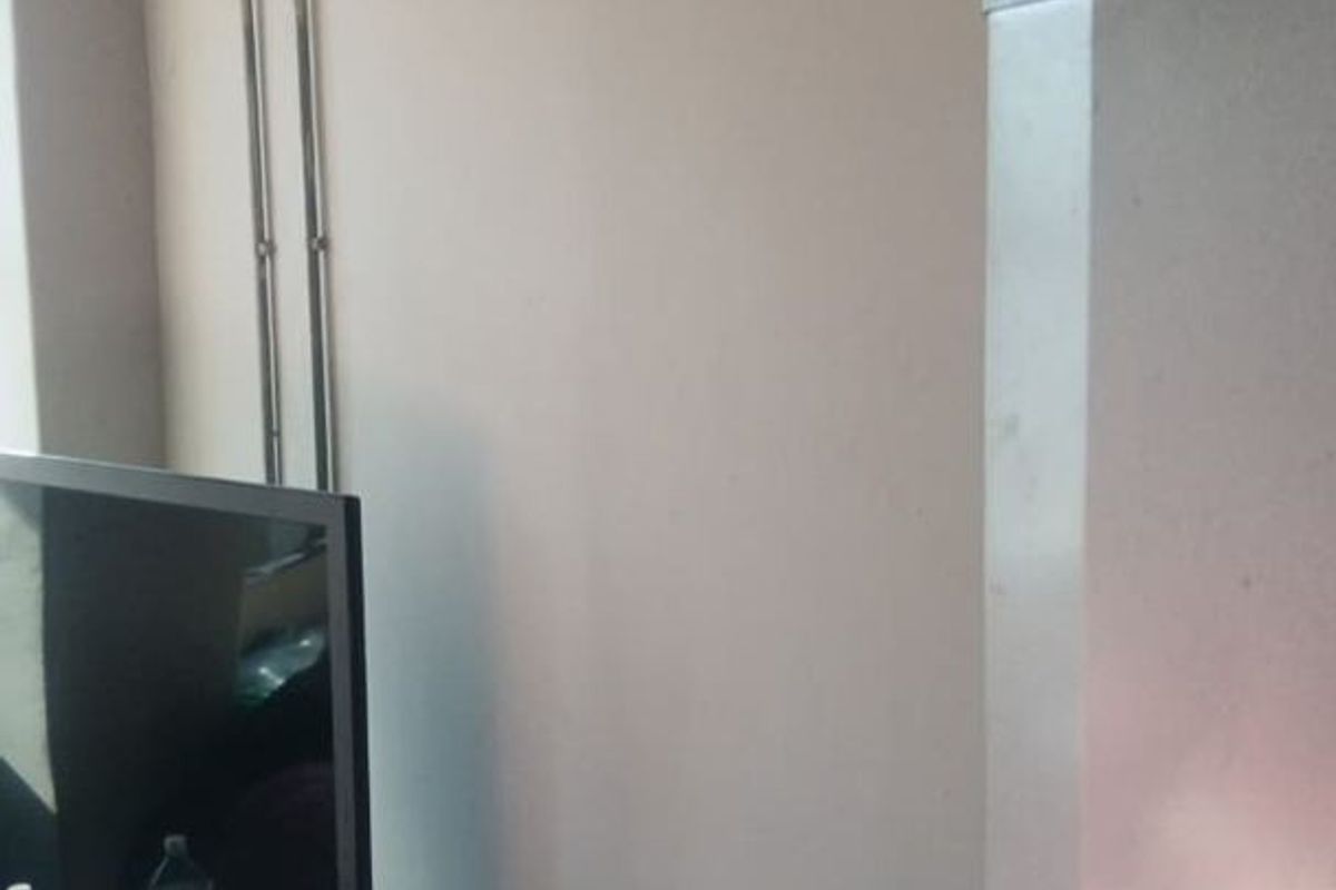 A living area space featuring visible surface-mounted electrical conduit along the wall, requiring cosmetic attention to improve the aesthetic appeal.
