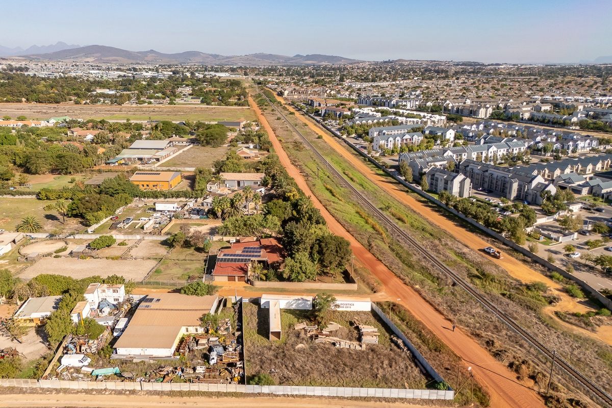 Aerial view of the residential property and surrounding area, featuring proximity to the railway line and local infrastructure.