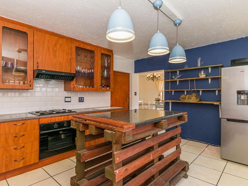 A functional kitchen featuring wooden cabinetry, granite countertops, subway tile backsplash, and built-in appliances, offering a solid foundation for modern updates.