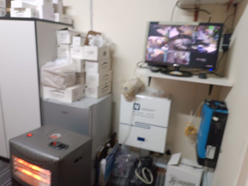 A utility space housing an inverter and battery backup system, along with a security monitoring station.