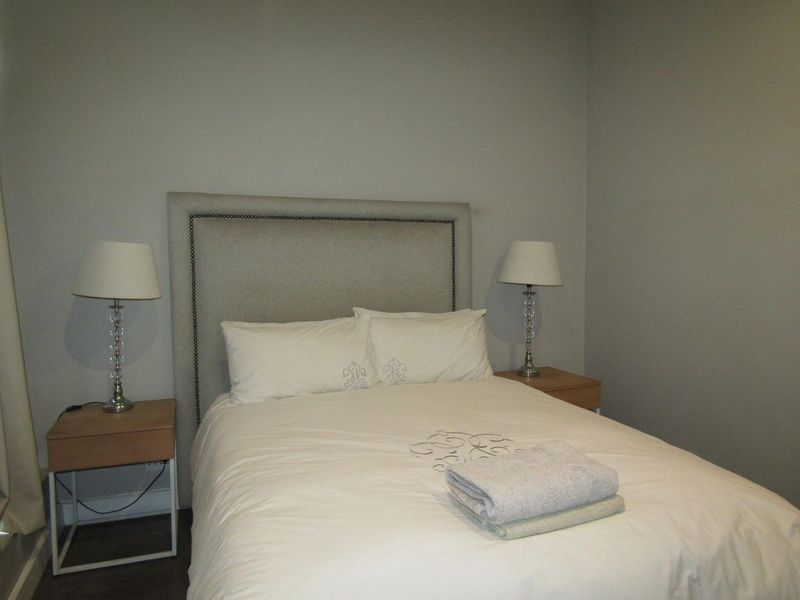 A simple bedroom featuring neutral wall tones and a clean, functional layout.