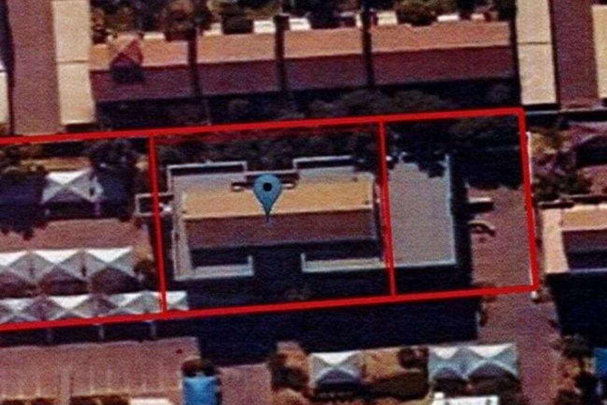 An aerial view showing the property site boundaries and the building roof structure within the surrounding commercial or residential context.