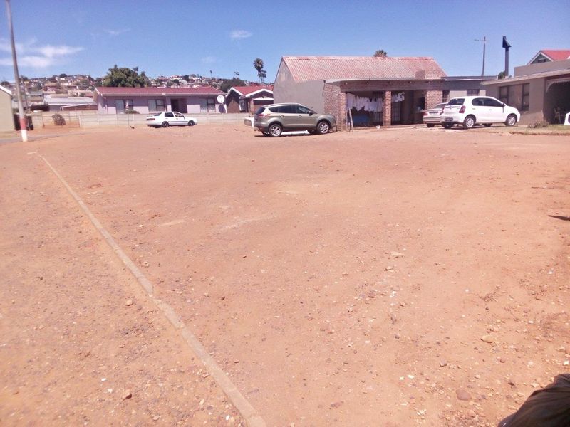 A vacant residential plot featuring an unpaved, level ground surface, suitable for future development in an established neighborhood setting.