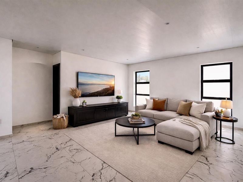 A modern, bright living room featuring high-quality marble-look floor tiles, recessed downlights, and large black-framed windows that provide ample natural light.
