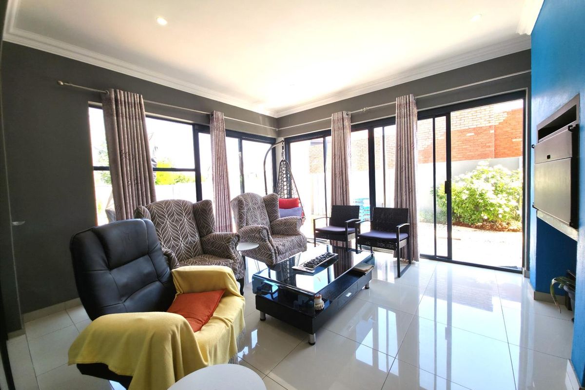 Spacious living room featuring large sliding glass doors that provide abundant natural light and direct access to the outdoor area.
